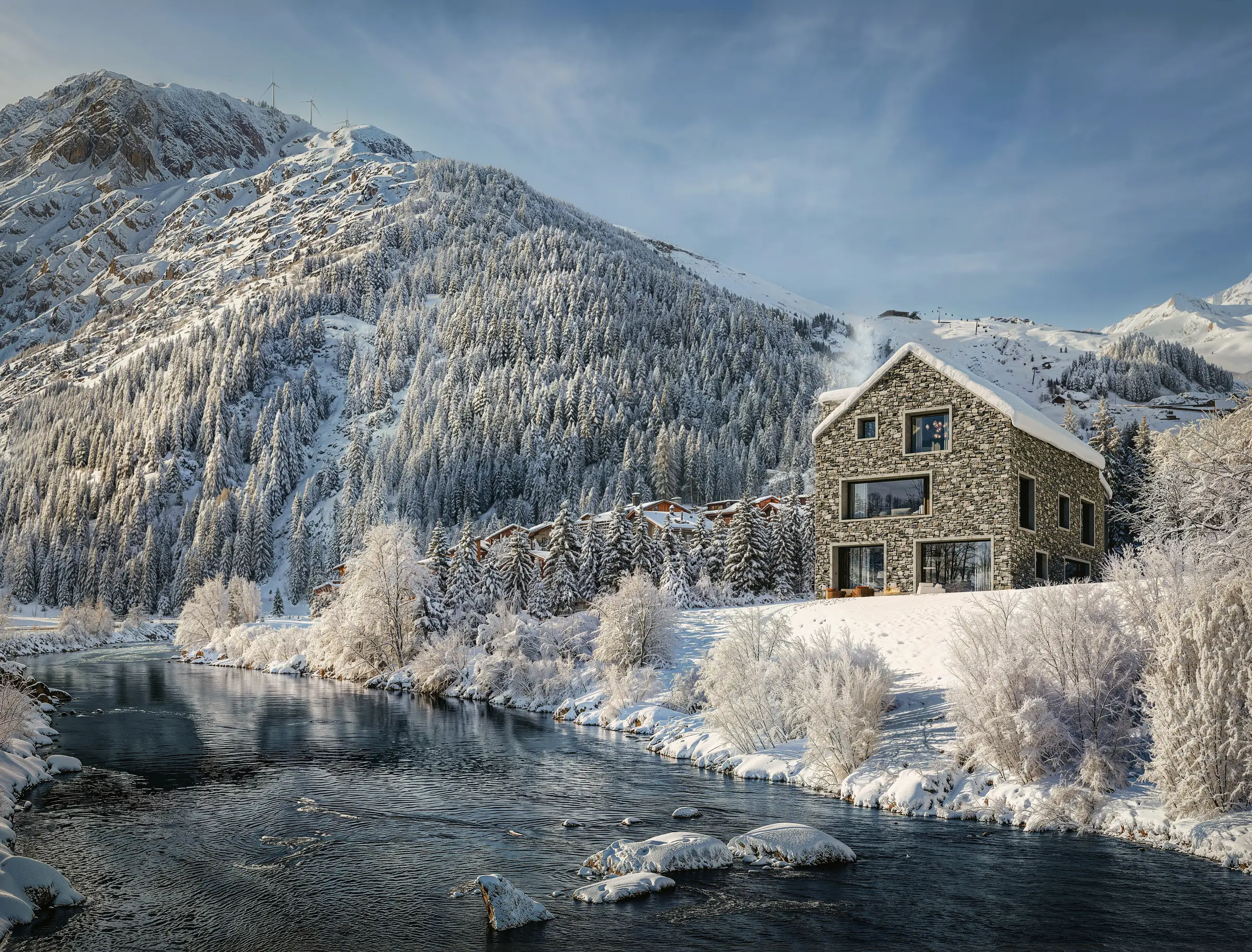 The River Reuss running past snow-covered trees and villas in Andermatt