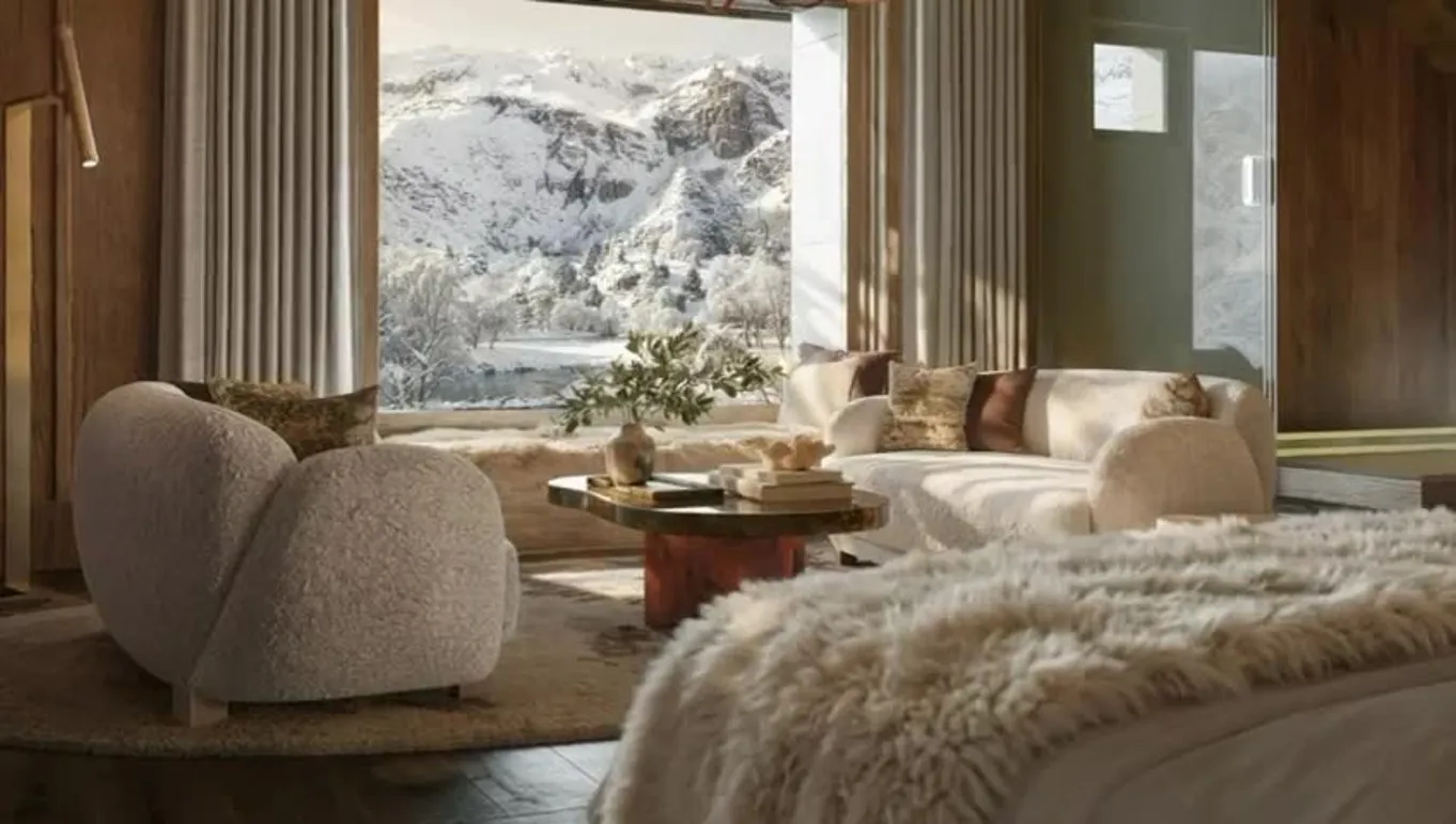 Fireside living space with sheepskin, blossom and a lit fireplace